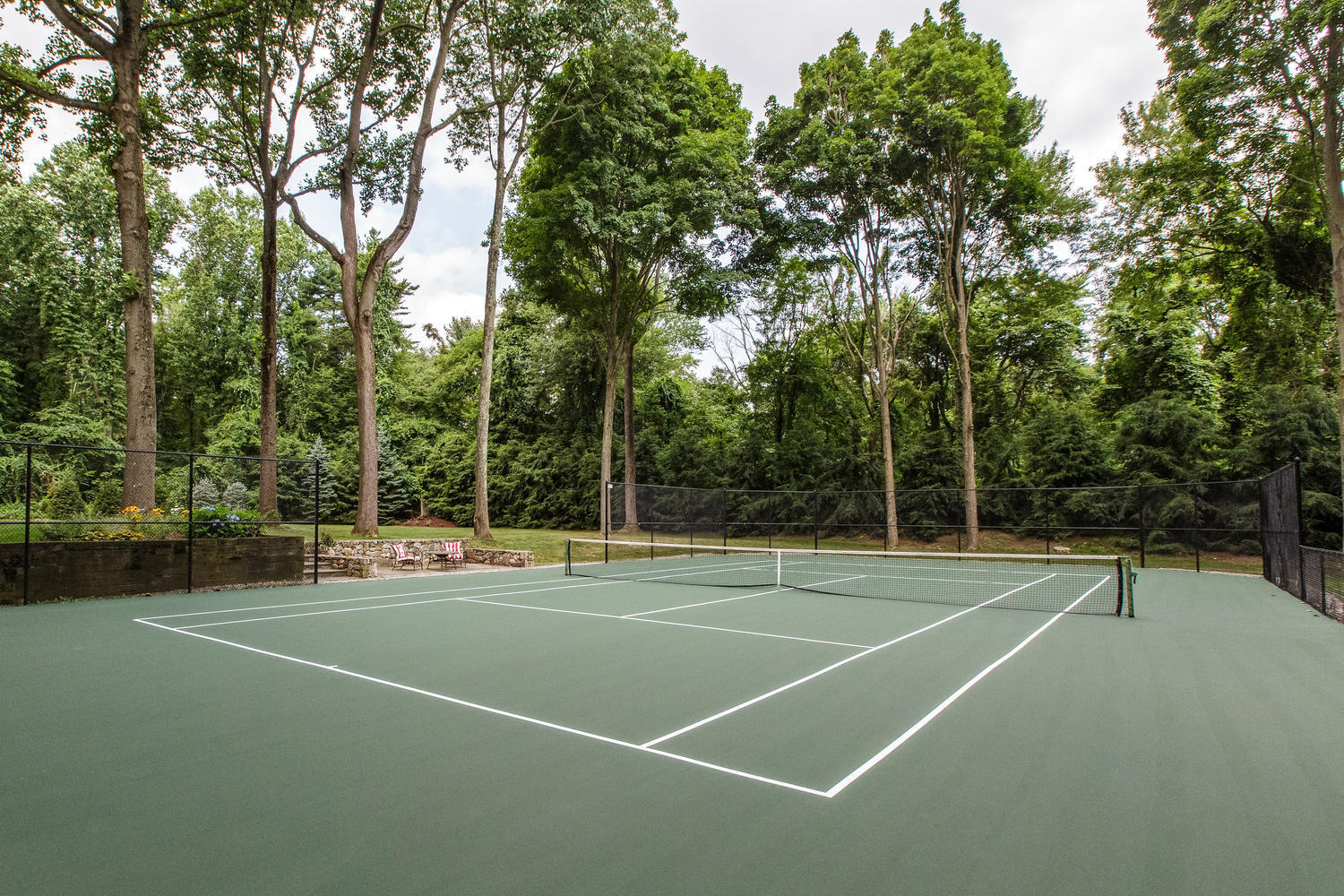 73 Talmadge Hill Road New Canaan, CT 06840 - Photo 34 of 37 a view of a tennis court with trees