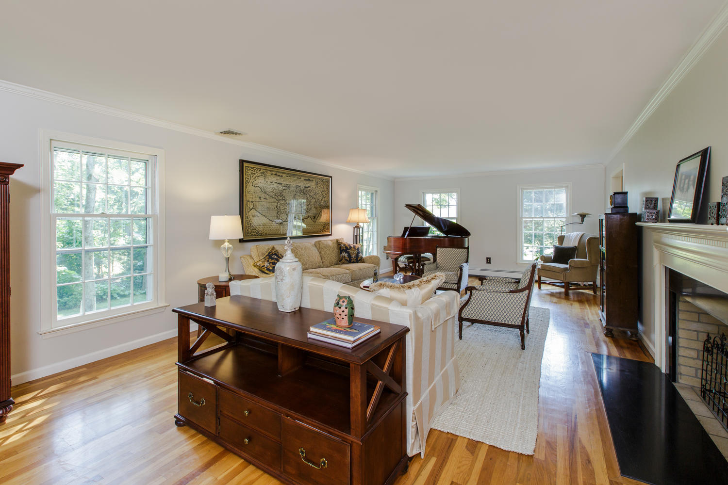73 Talmadge Hill Road New Canaan, CT 06840 - Photo 5 of 37 a living room with furniture a fireplace and a large window