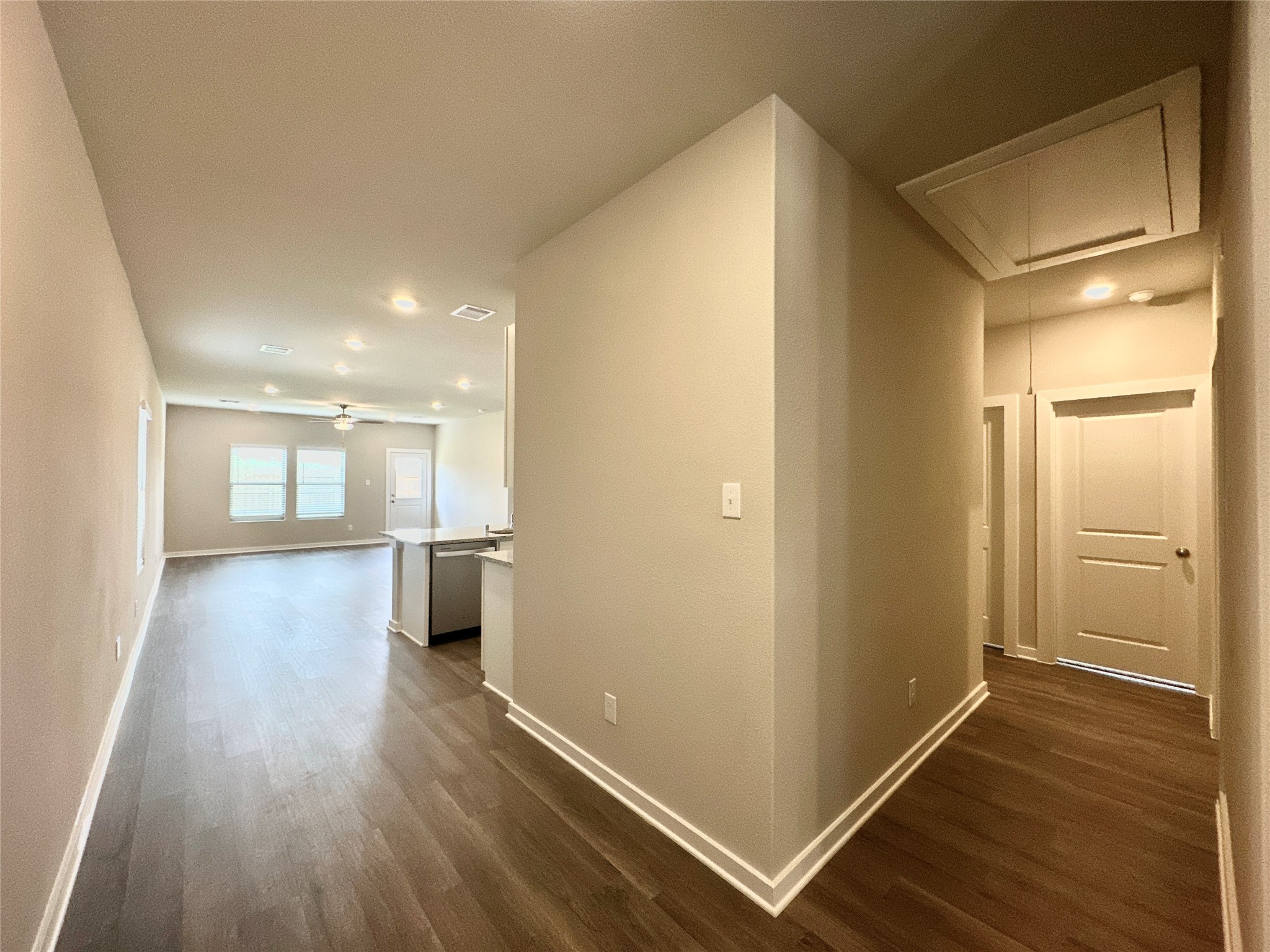 12164 Ridge Top Drive Conroe, TX 77304 - Photo 23 of 23 a view of a hallway with wooden floor and a kitchen