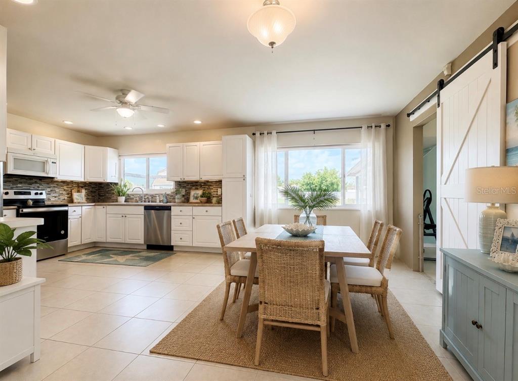 2755 Greendale Road North Port, FL 34287 - Photo 3 of 43 a kitchen with a dining table chairs and refrigerator