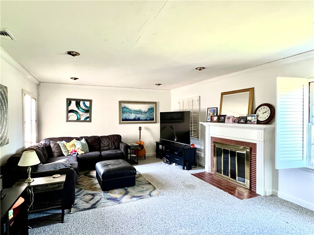 1100 Drake Road Arcadia, CA 91007 - Photo 2 of 21 a living room with furniture a fireplace and a flat screen tv