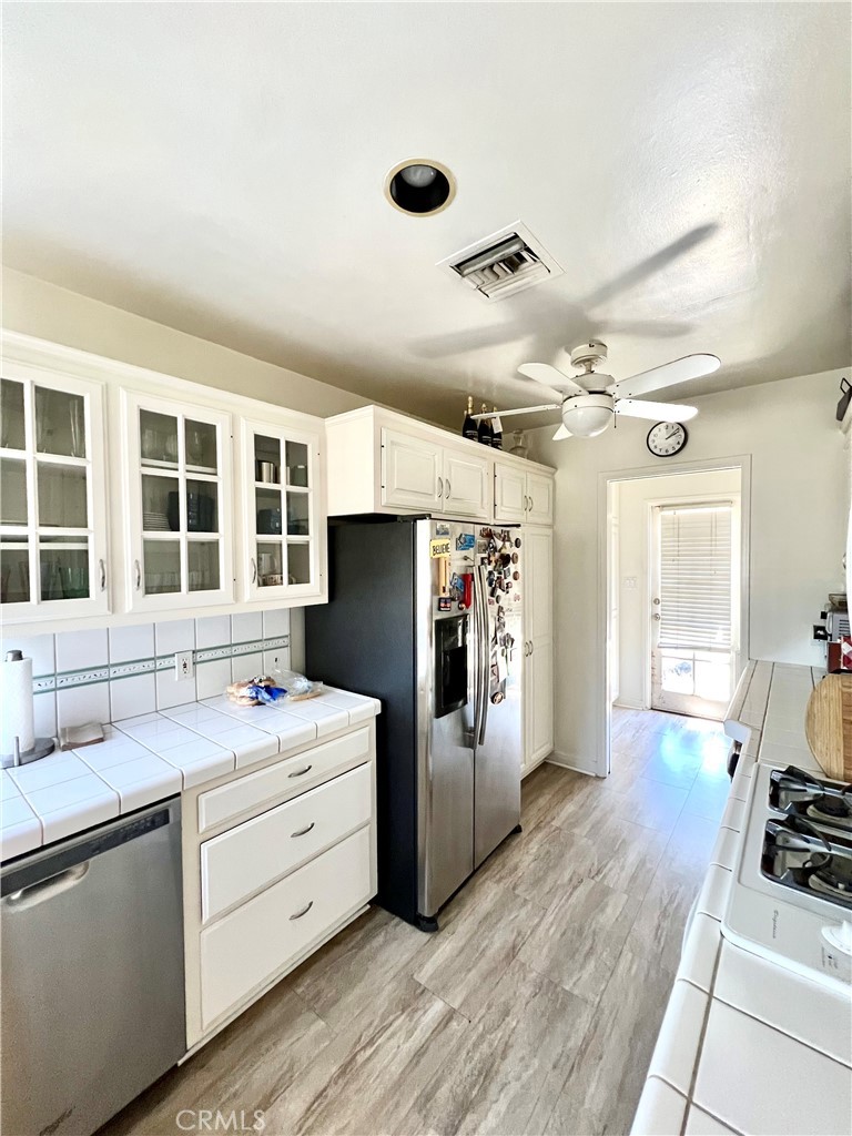 1100 Drake Road Arcadia, CA 91007 - Photo 4 of 21 a kitchen with stainless steel appliances kitchen island granite countertop a refrigerator and a stove top oven