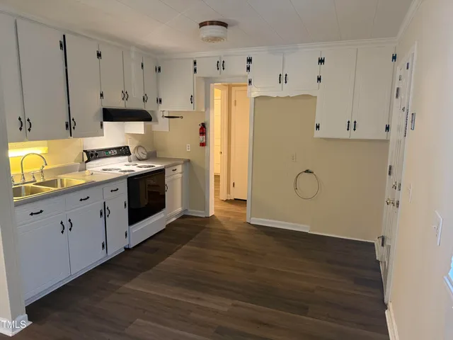 a view of a kitchen with wooden floor
