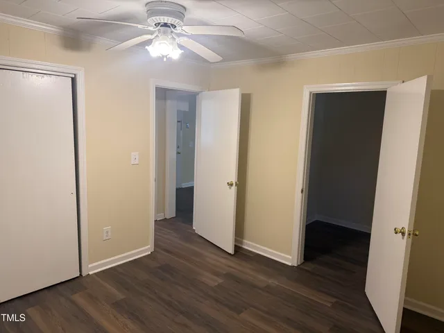 a view of an empty room with wooden floor