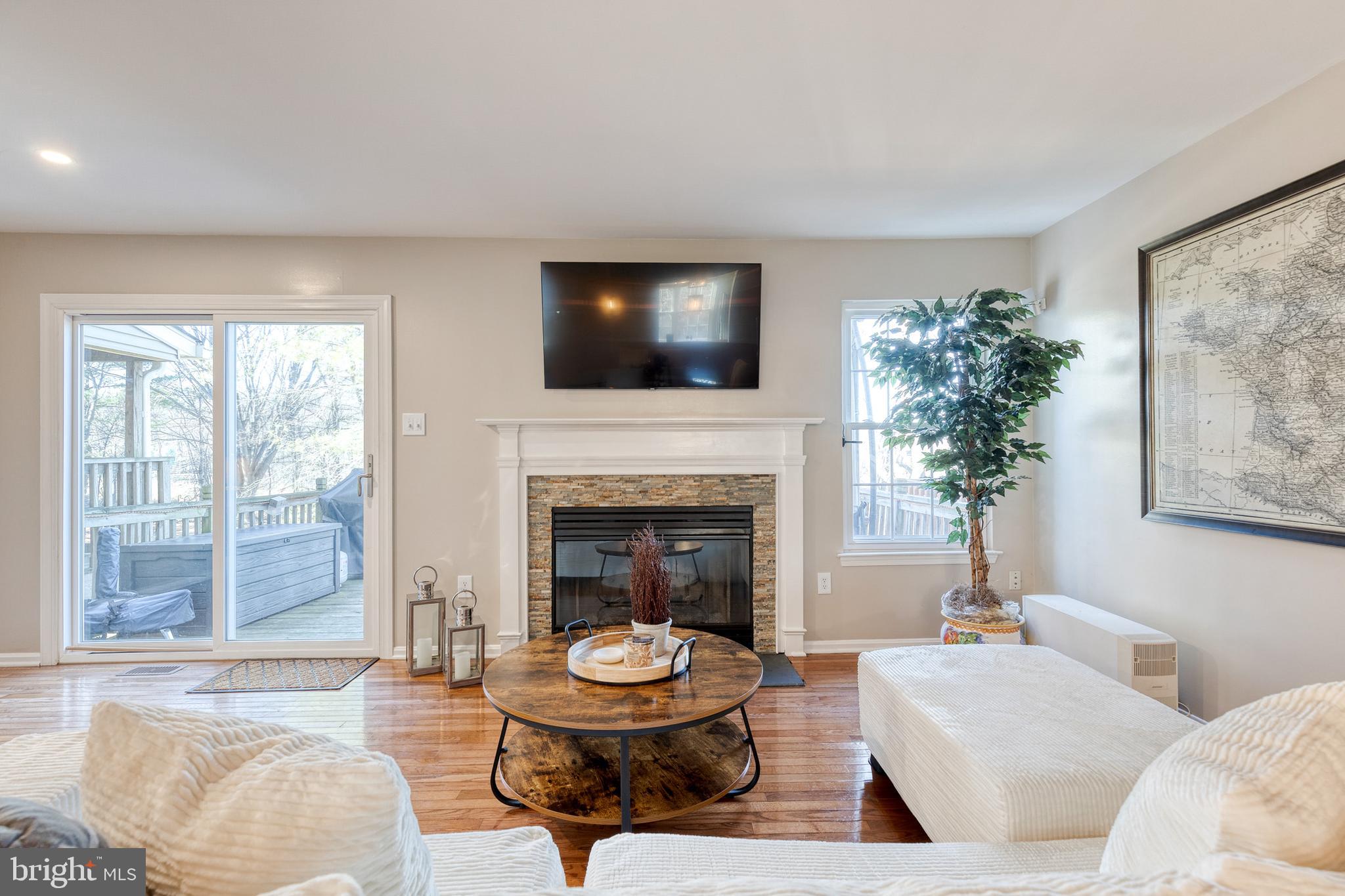 8743 Ruppert Court Ellicott City, MD 21043 - Photo 12 of 41 a living room with furniture a window and a fireplace