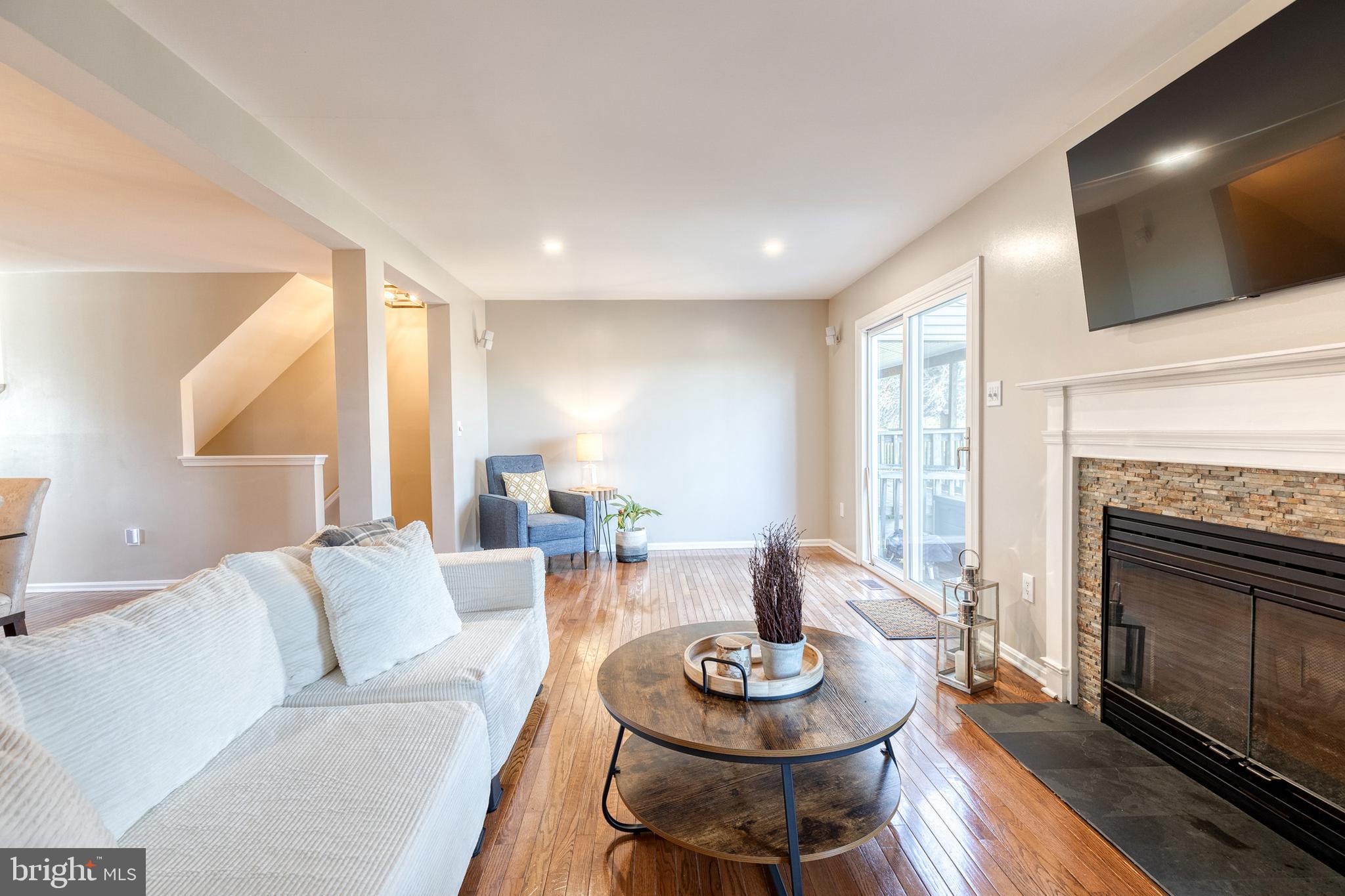 8743 Ruppert Court Ellicott City, MD 21043 - Photo 14 of 41 a living room with furniture a fireplace and a flat screen tv