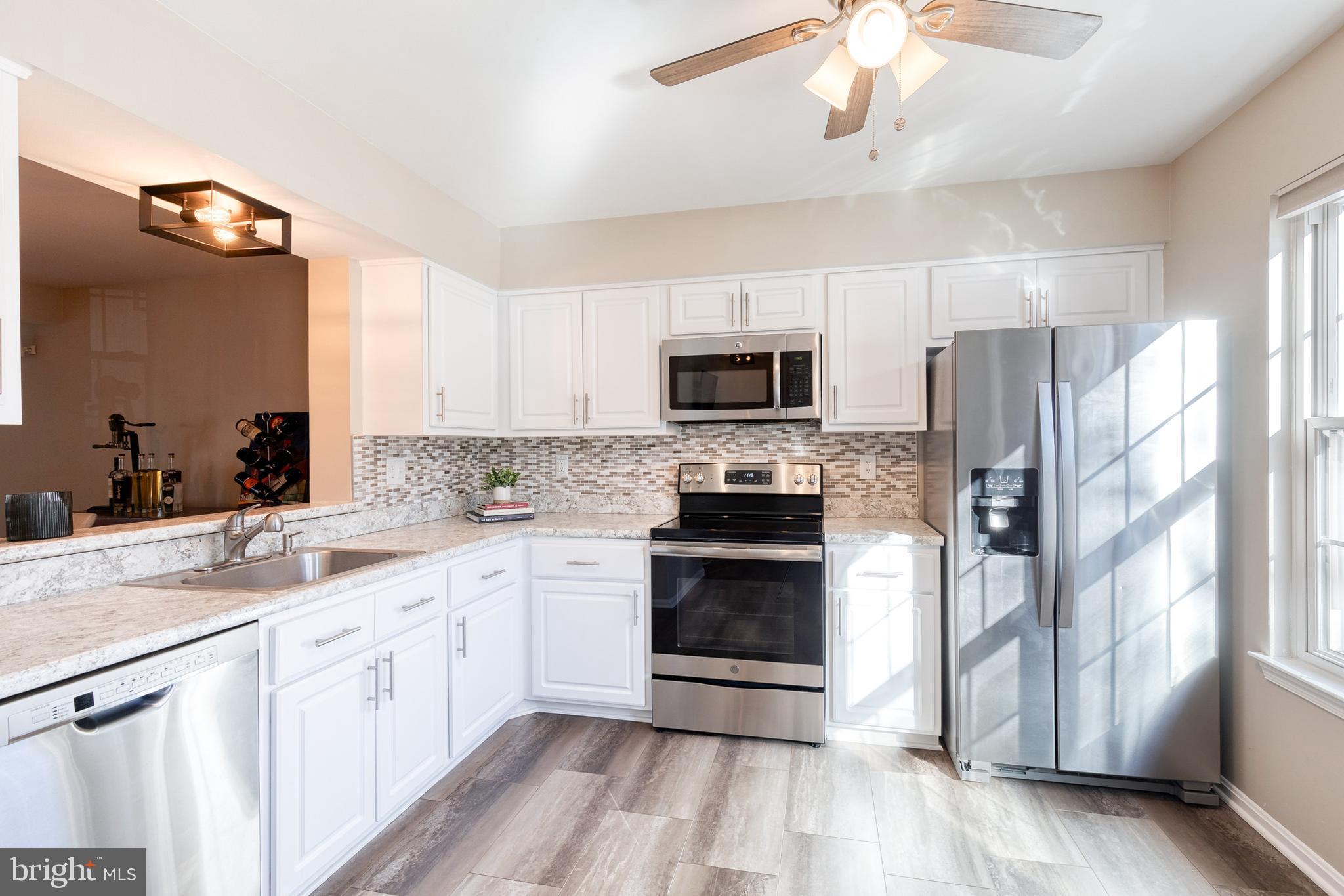 8743 Ruppert Court Ellicott City, MD 21043 - Photo 23 of 41 a kitchen with a sink stove and microwave