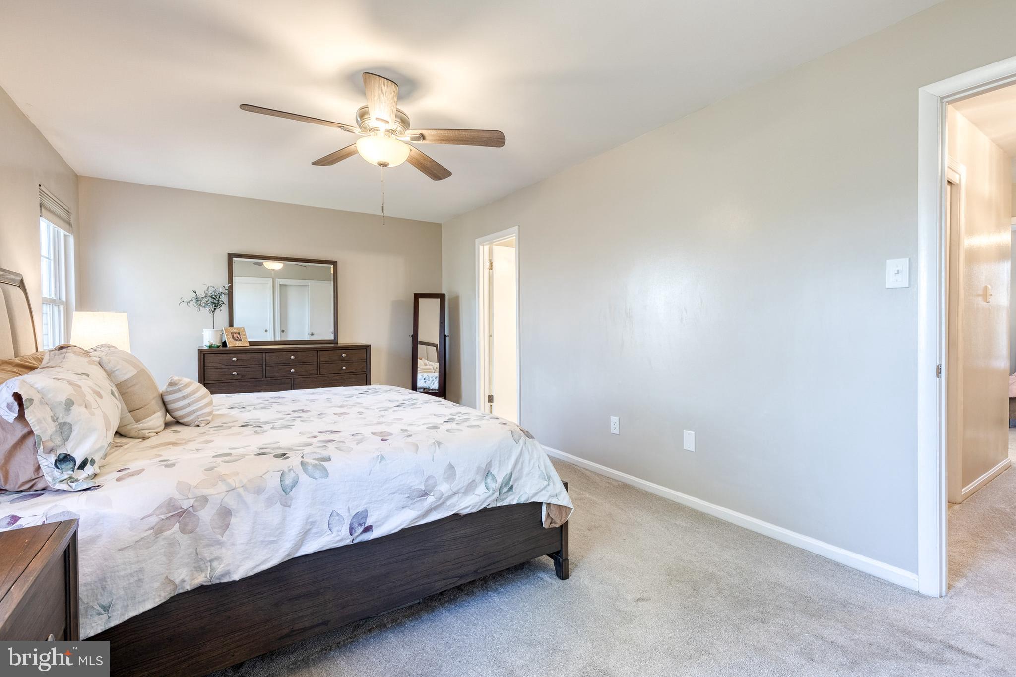 8743 Ruppert Court Ellicott City, MD 21043 - Photo 29 of 41 a bedroom with a bed and a chandelier