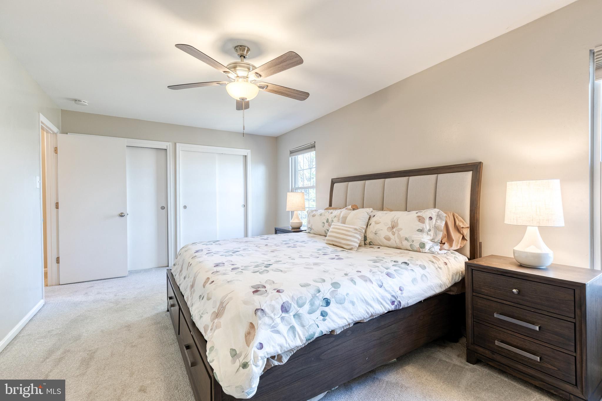 8743 Ruppert Court Ellicott City, MD 21043 - Photo 30 of 41 a bedroom with a large bed and a chandelier