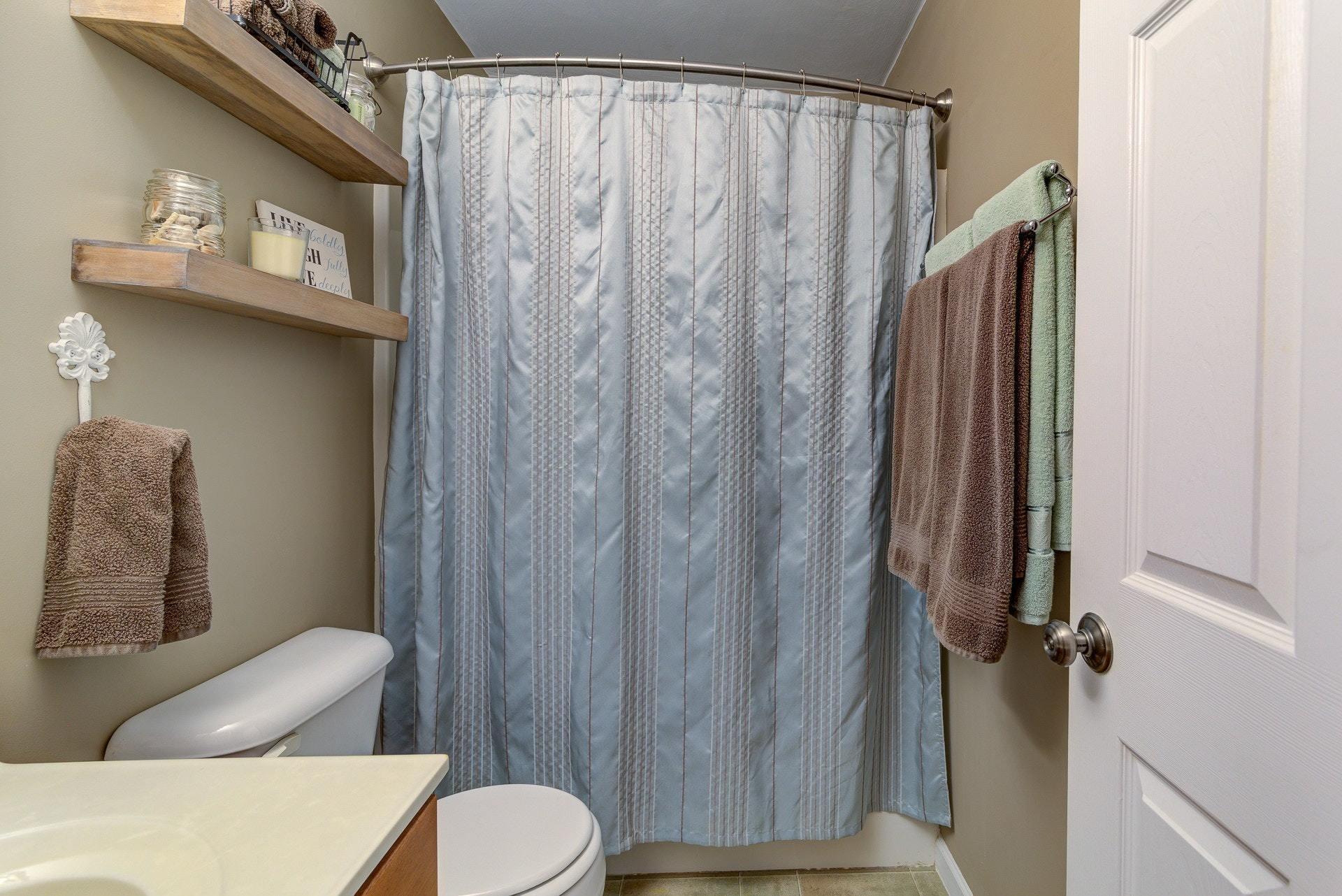5893 Hardy Road Hardy, VA 24101 - Photo 14 of 37 a bathroom with a toilet and a shower curtain