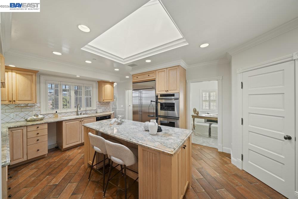 5280 Sheridan Road Sunol, CA 94586 - Photo 22 of 60 a kitchen with center island and stainless steel appliances