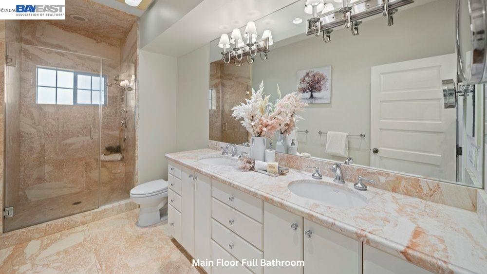 5280 Sheridan Road Sunol, CA 94586 - Photo 30 of 60 a bathroom with a granite countertop sink a toilet and shower