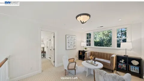 a living room with furniture a fireplace and a table