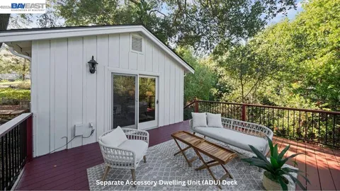 a view of a patio with a table and chairs and potted plants