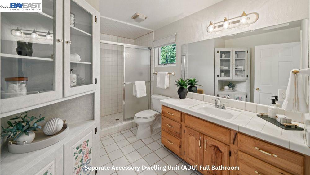 5280 Sheridan Road Sunol, CA 94586 - Photo 45 of 60 a spacious bathroom with a double vanity sink toilet and a shower