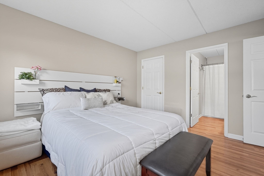 16 Maple Crest Circle, Unit B Holyoke, MA 01040 - Photo 12 of 24 a bedroom with a bed and wooden floor