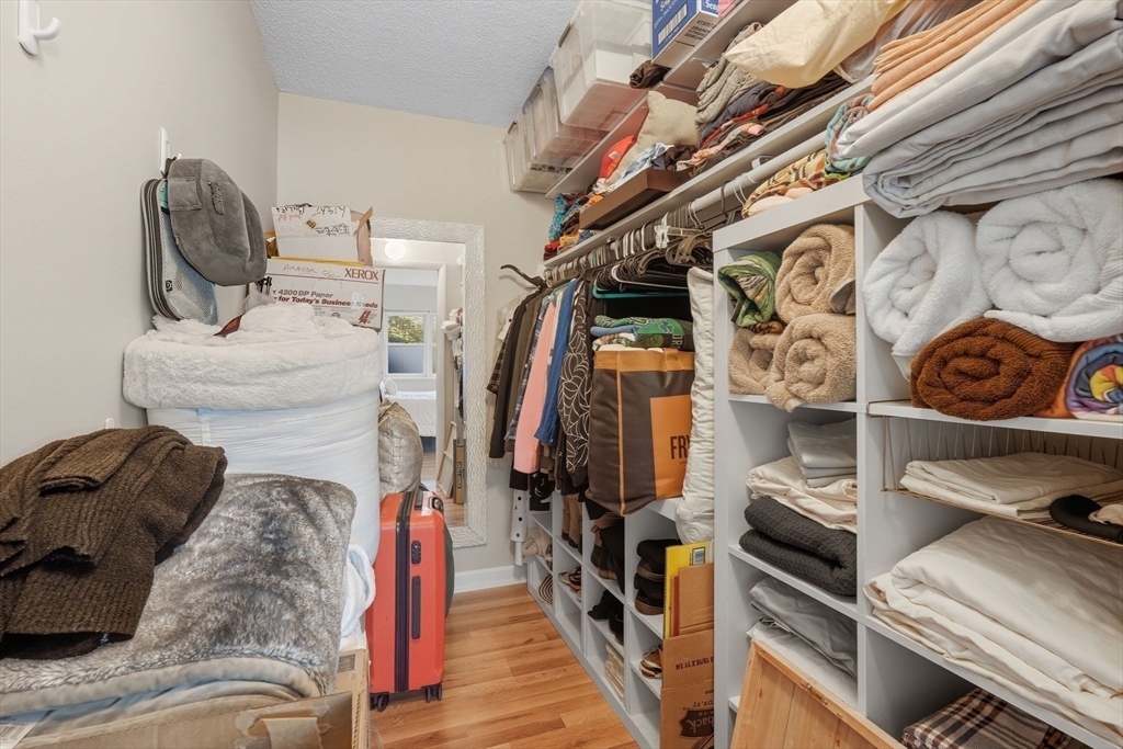 16 Maple Crest Circle, Unit B Holyoke, MA 01040 - Photo 13 of 24 a view of walk in closet with clothes and shoes