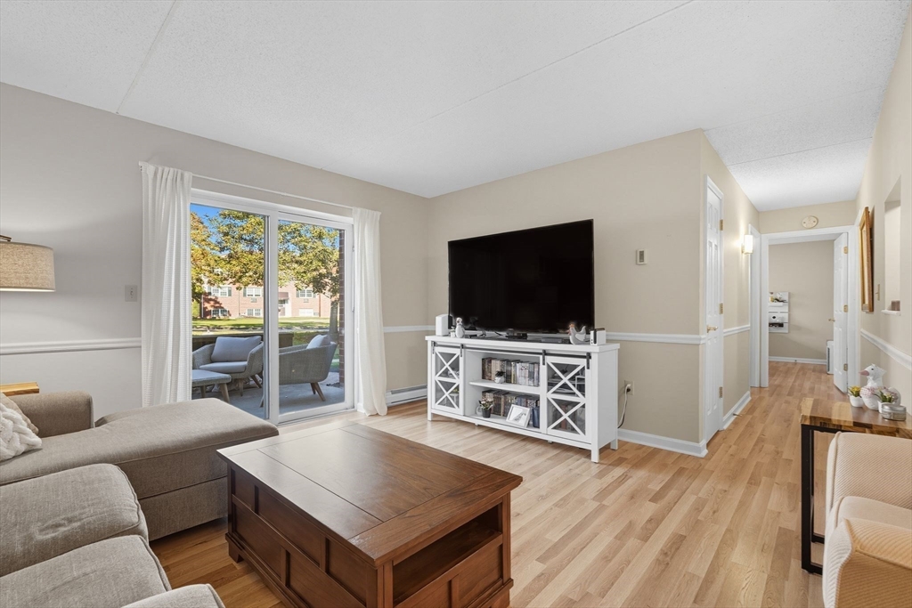 16 Maple Crest Circle, Unit B Holyoke, MA 01040 - Photo 3 of 24 a living room with furniture and a flat screen tv