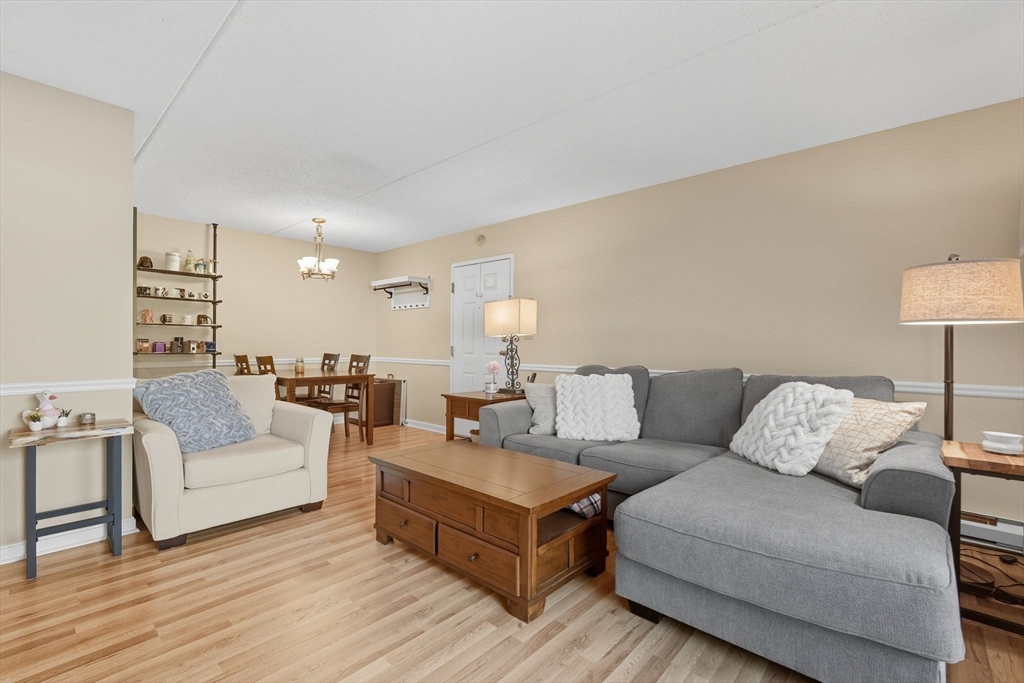 16 Maple Crest Circle, Unit B Holyoke, MA 01040 - Photo 4 of 24 a living room with furniture and a lamp on table with wooden floor