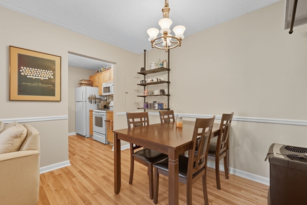 16 Maple Crest Circle, Unit B Holyoke, MA 01040 - Photo 5 of 24 a view of a dining room with furniture and wooden floor
