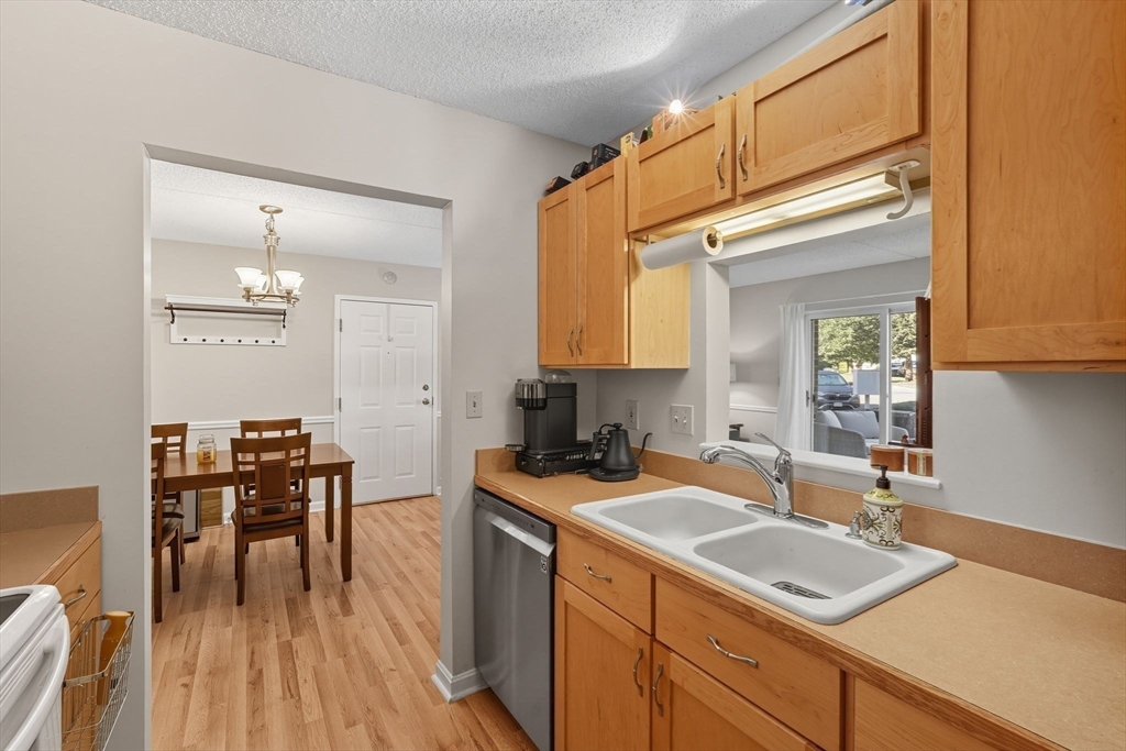 16 Maple Crest Circle, Unit B Holyoke, MA 01040 - Photo 6 of 24 a kitchen with a sink a stove cabinets and wooden floor