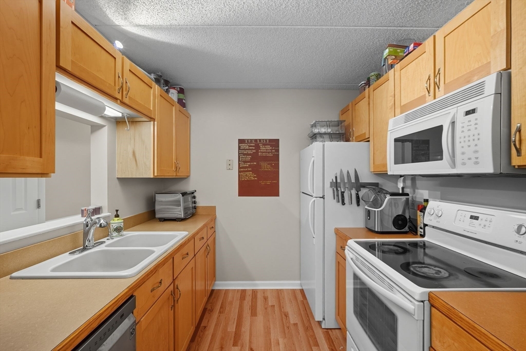 16 Maple Crest Circle, Unit B Holyoke, MA 01040 - Photo 7 of 24 a kitchen with a sink stove and microwave