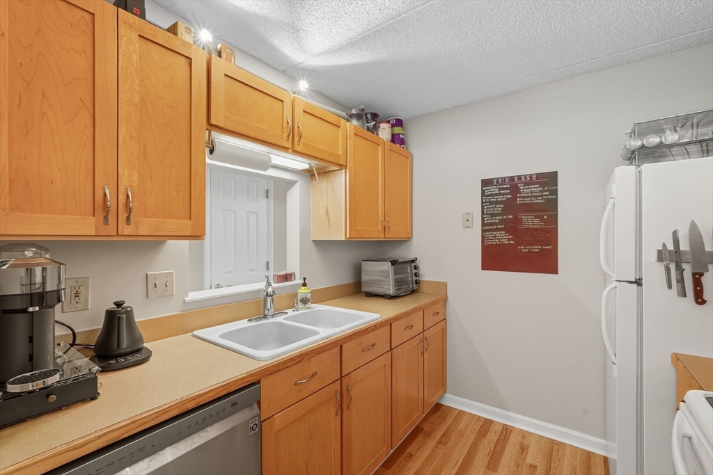 16 Maple Crest Circle, Unit B Holyoke, MA 01040 - Photo 8 of 24 a kitchen with a sink cabinets and a wooden floor