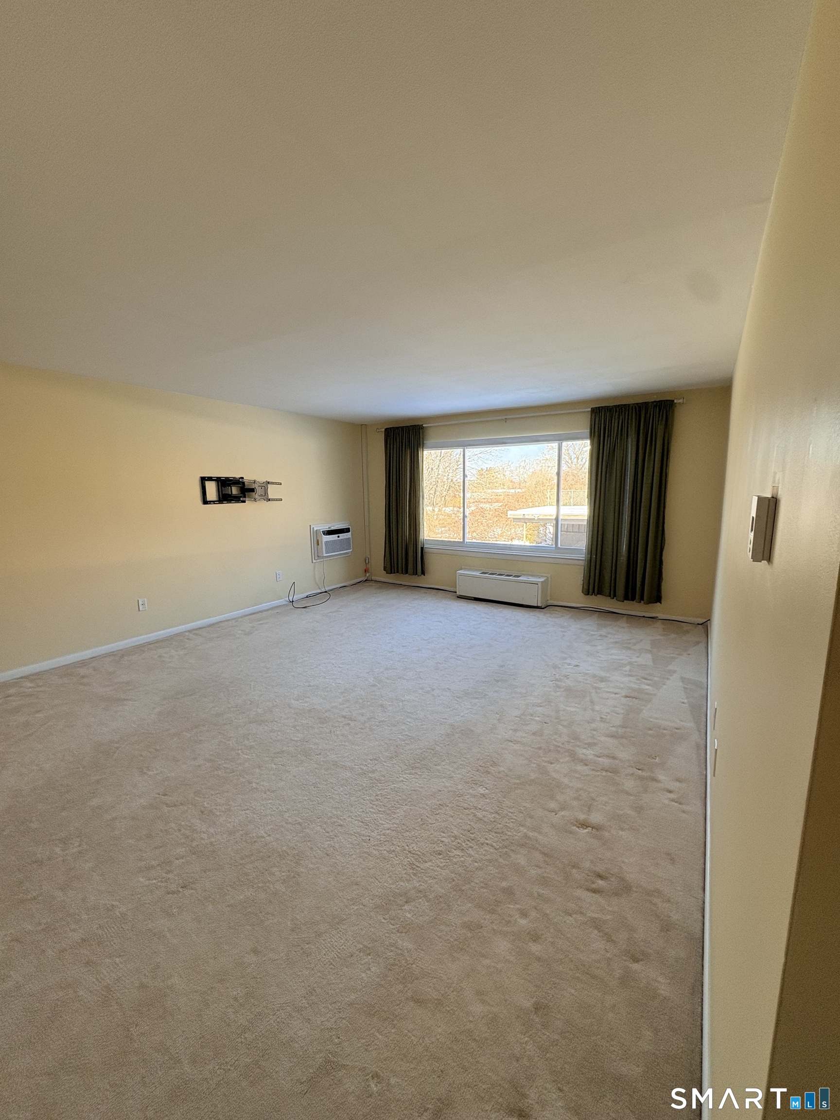 57 Westridge Road, Unit B9 New London, CT 06320 - Photo 4 of 13 a view of an empty room with window and a fireplace