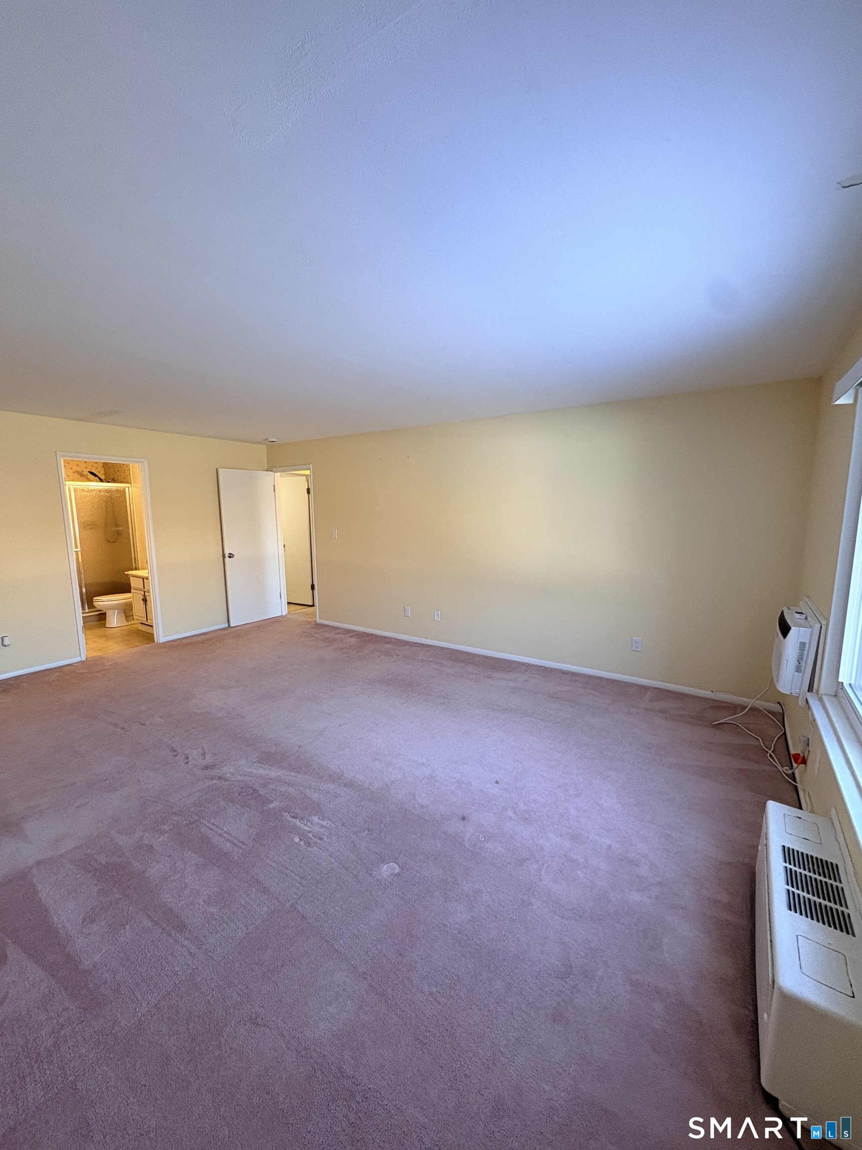 57 Westridge Road, Unit B9 New London, CT 06320 - Photo 10 of 13 an empty room with windows and fireplace