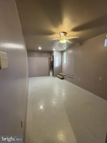 a view of a livingroom with a ceiling fan and chandelier fan