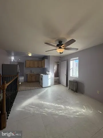 a view of a livingroom with a ceiling fan and window