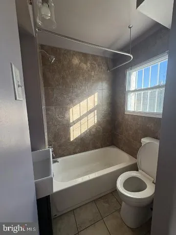 a bathroom with a toilet and a tub