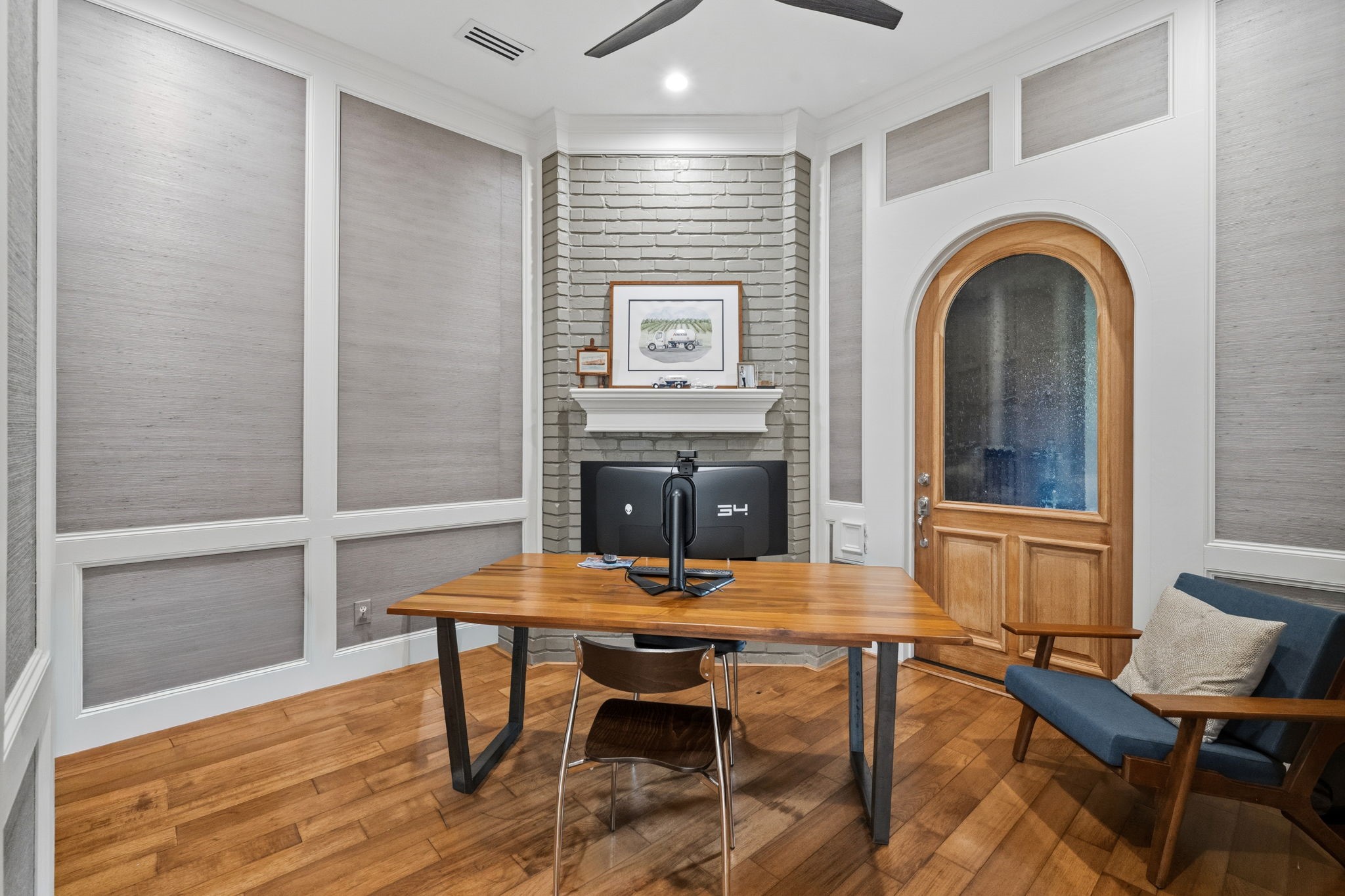 43 Firefall Court Spring, TX 77380 - Photo 17 of 48 Currently used as a home office, this versatile room features wood floors, a fireplace, custom wall treatments, and direct access to the temperature-controlled wine room.