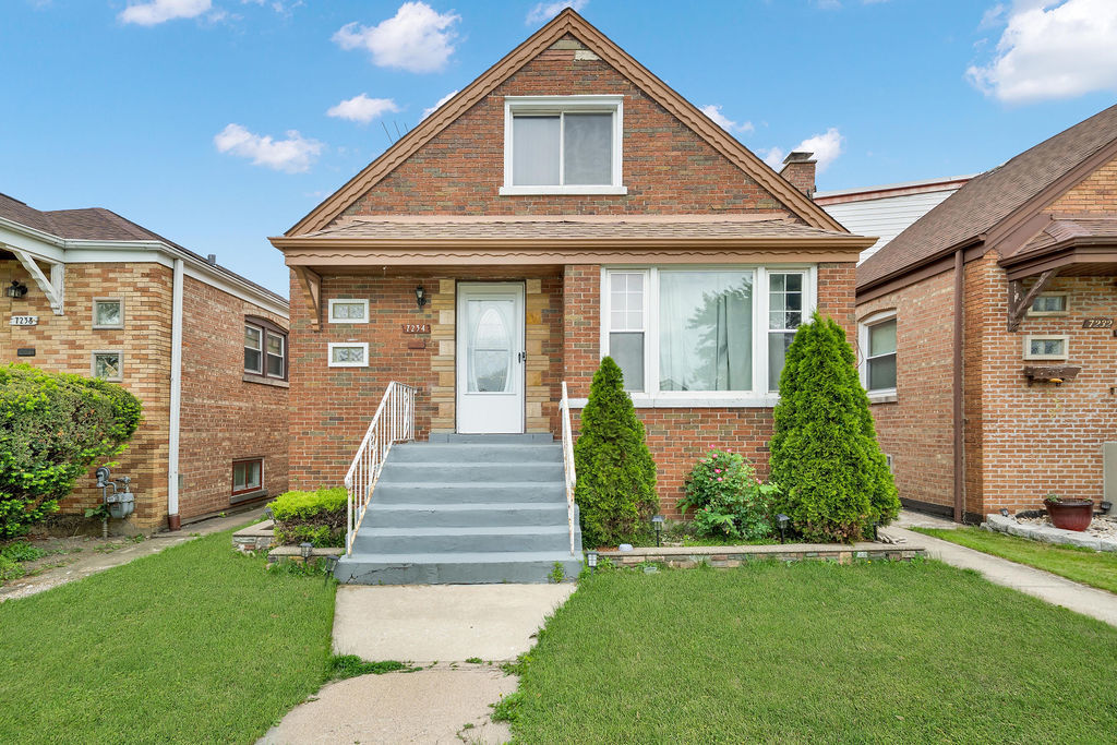 7234 South Ridgeway Avenue Chicago, IL 60629 - Photo 1 of 27 a front view of a house with a yard