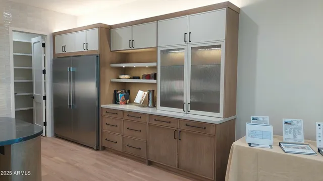 a kitchen with stainless steel appliances a refrigerator and cabinets