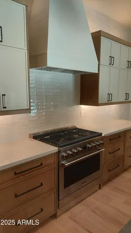 a stove top oven sitting inside of a kitchen