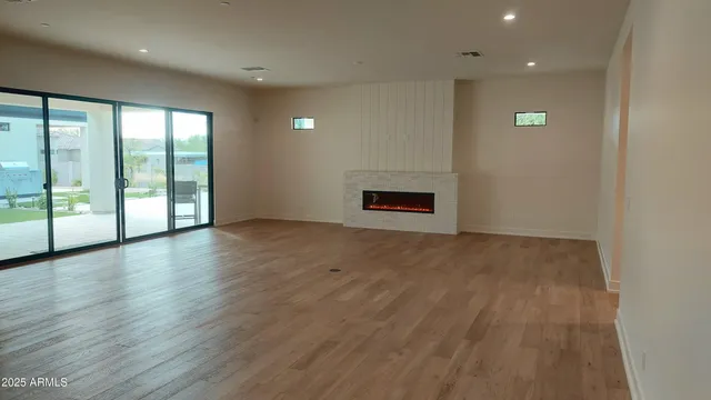 an empty room with windows and closet