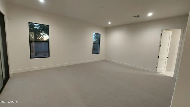 an empty room with windows and closet