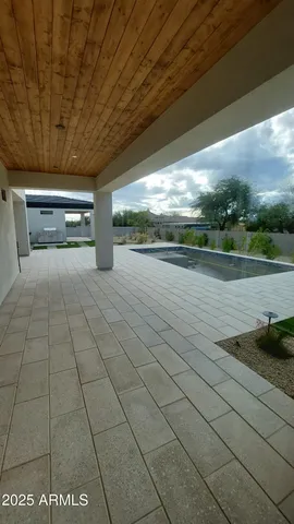 a view of yard with swimming pool and trees