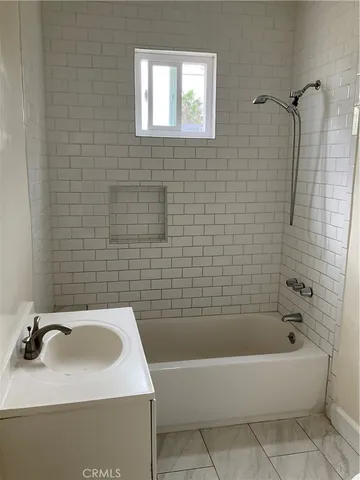 a bathroom with a sink a bathtub and a shower