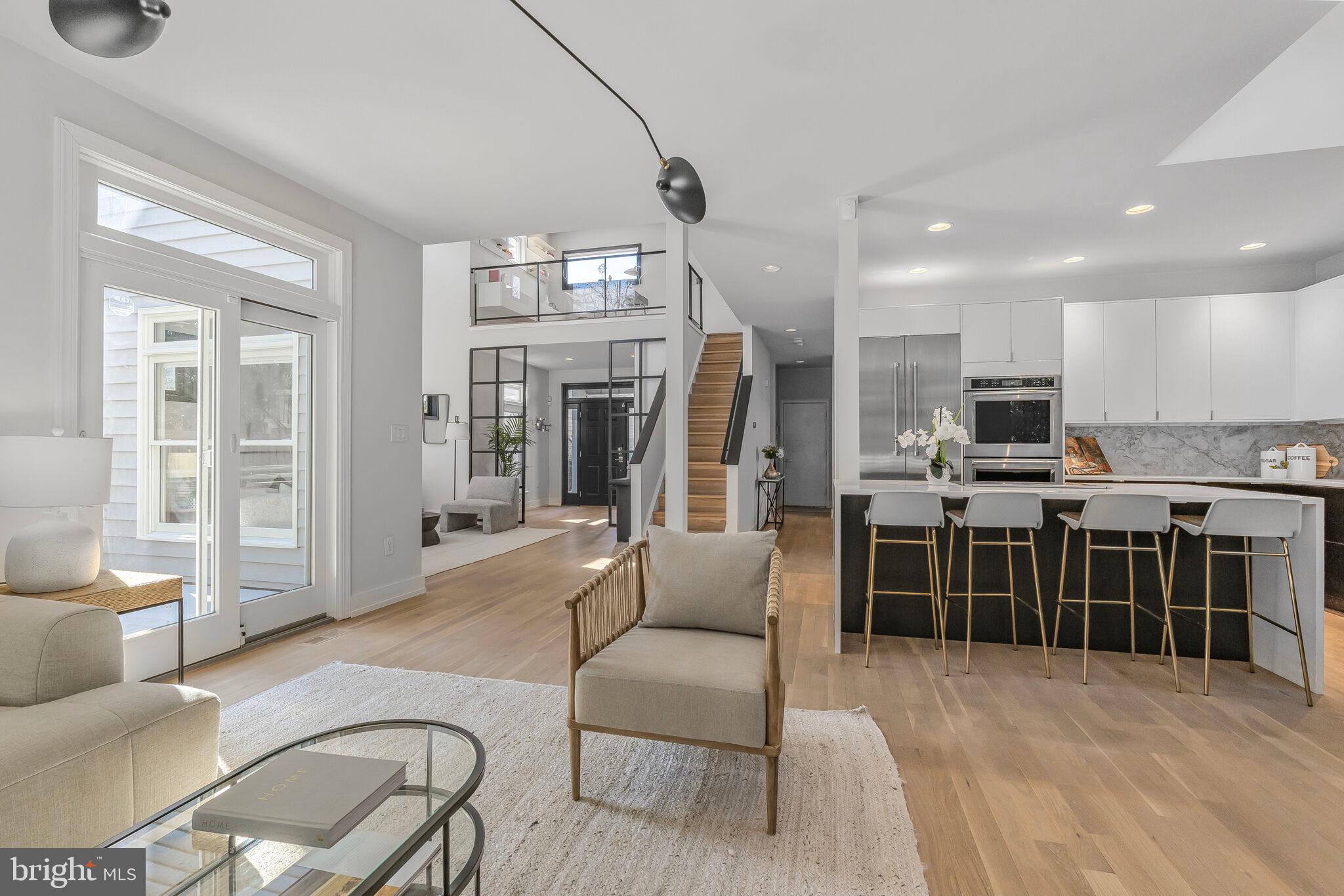 2009 Beacon Place Reston, VA 20191 - Photo 16 of 40 a living room with stainless steel appliances furniture a flat screen tv and a faucet