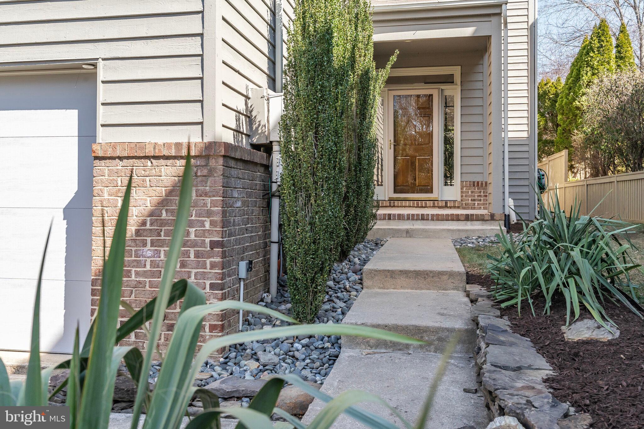 2009 Beacon Place Reston, VA 20191 - Photo 2 of 40 a couple of potted plants in front of door
