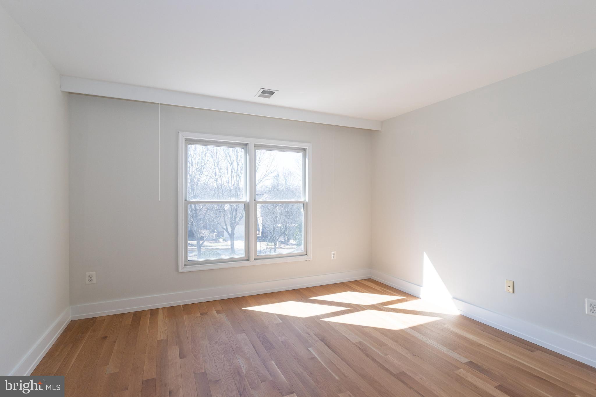 2009 Beacon Place Reston, VA 20191 - Photo 32 of 40 an empty room with wooden floor and windows
