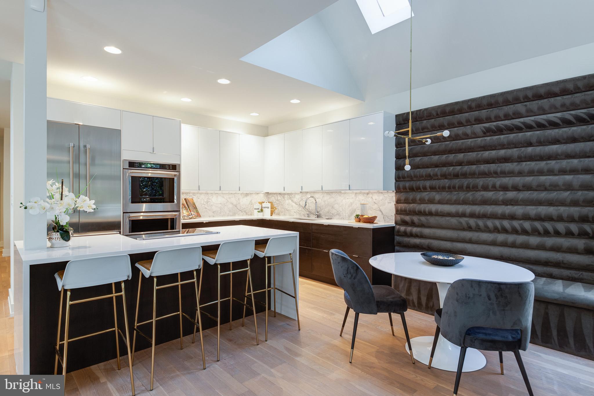 2009 Beacon Place Reston, VA 20191 - Photo 8 of 40 a kitchen with a table chairs sink and cabinets