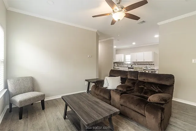 a living room with furniture and a wooden floor