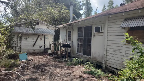 a view of a house with a yard and sitting area