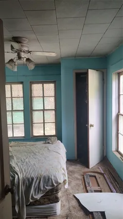 a spacious bedroom with a bed and a window