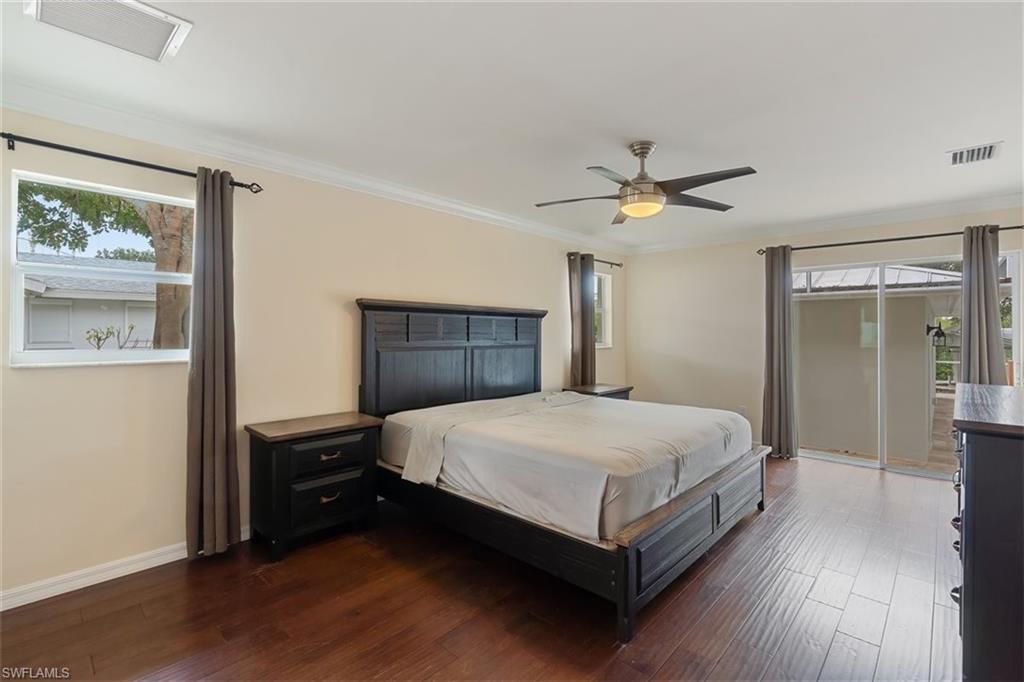 4851 Riverside Drive Estero, FL 33928 - Photo 19 of 35 a bedroom with a bed and a table