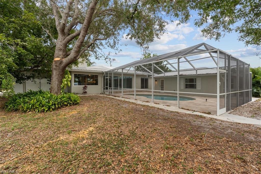 4851 Riverside Drive Estero, FL 33928 - Photo 25 of 35 a view of a house with a yard and large tree