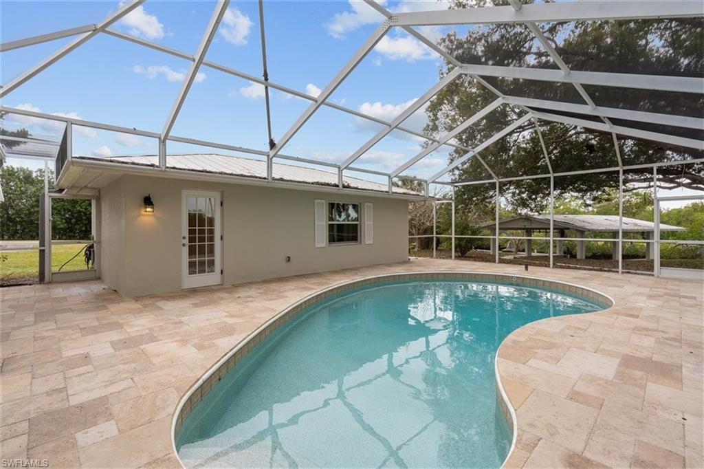 4851 Riverside Drive Estero, FL 33928 - Photo 28 of 35 a view of a backyard with a swimming pool